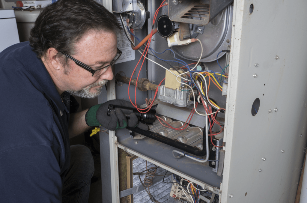 HVAC technician checking furnace