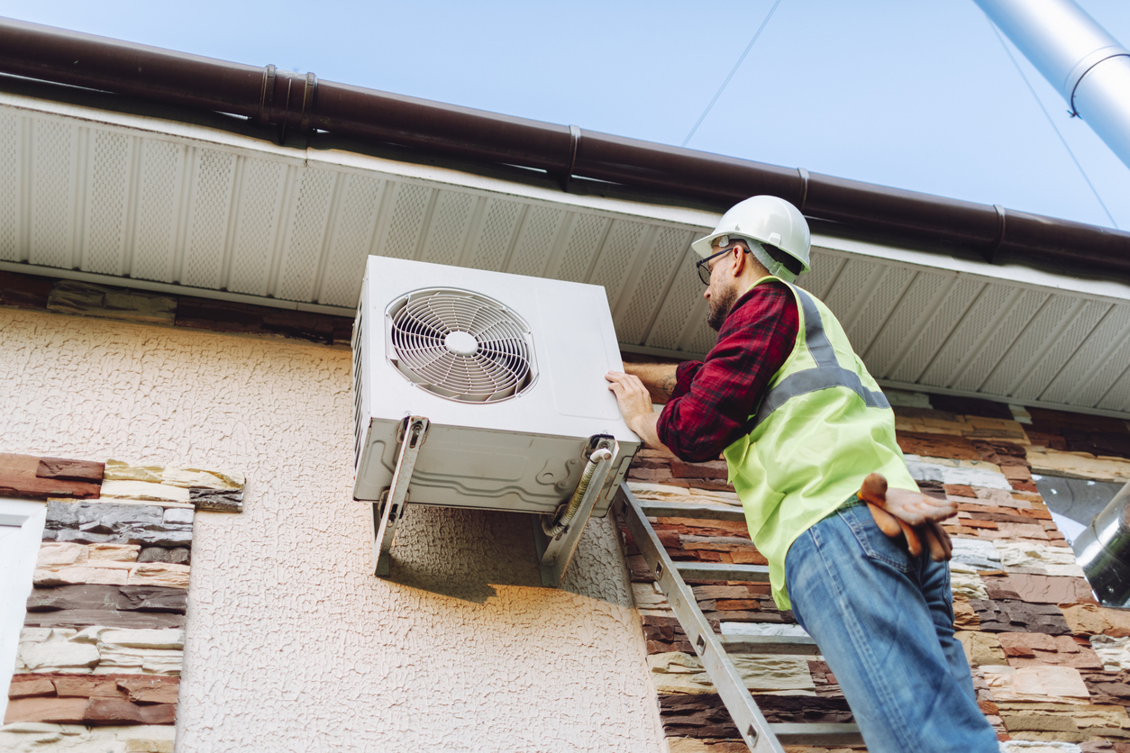 HVAC technician working on outside unit